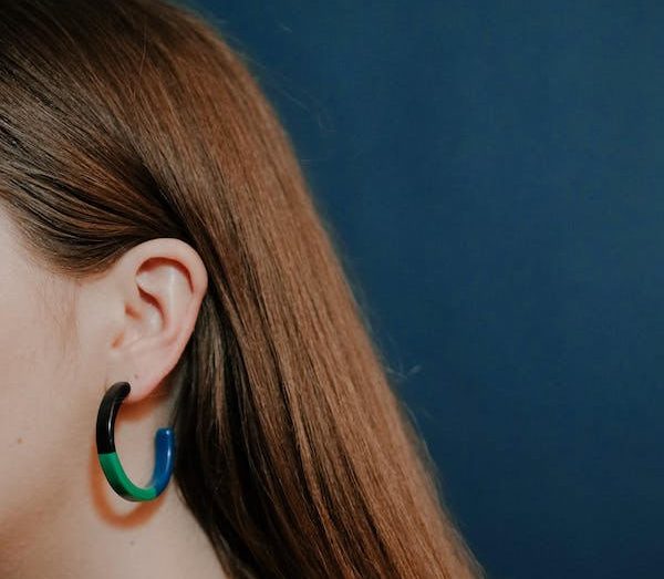 side of woman's face showing her ear and earrings