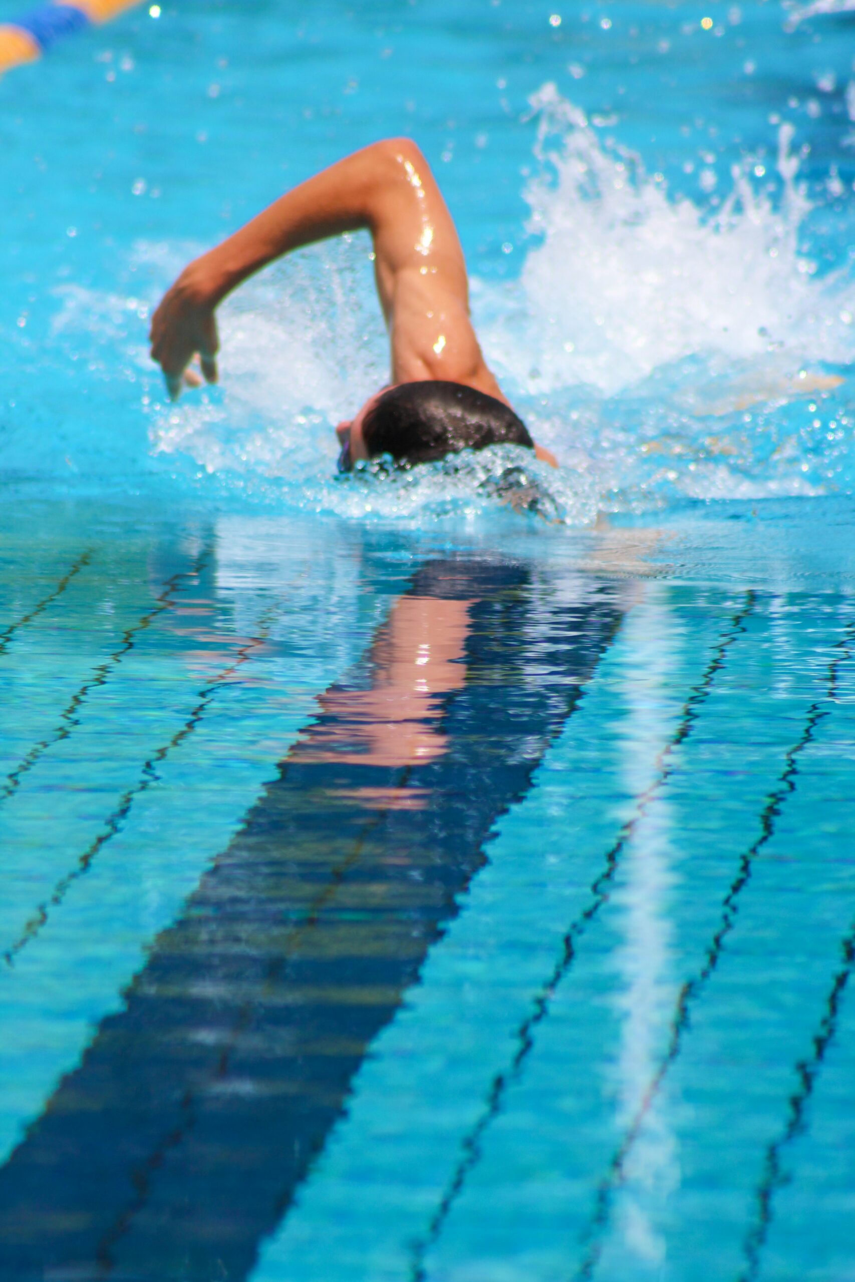 man swimming in long indoor pool representing our swimmer's ear treatments in Boise